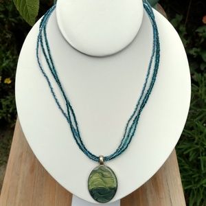 KC green pendant on blue & green seed bead strands